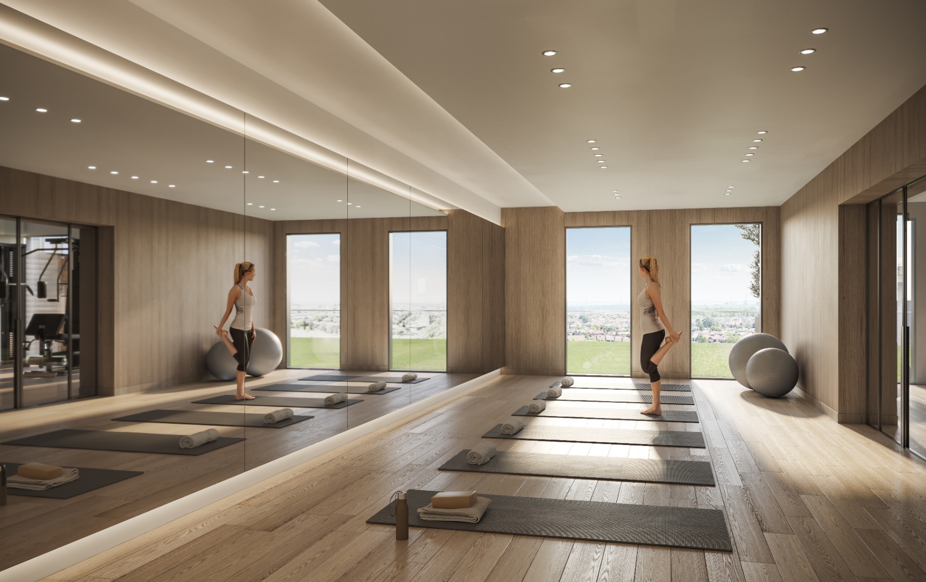 Minimalist yoga studio with light wood floors and large windows