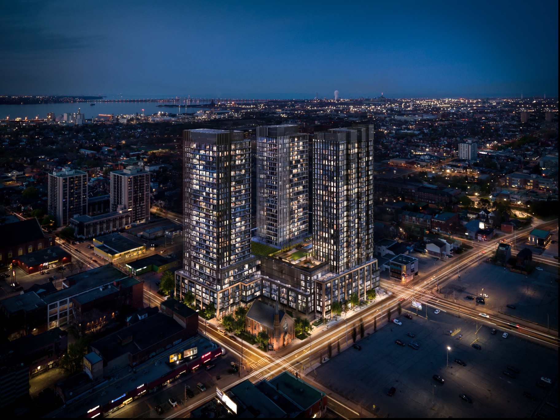 Aerial · 41 Wilson St W — Design District Condos Hamilton at 41 Wilson St W. Three towers rising above downtown Hamilton, framed by the harbourfront.